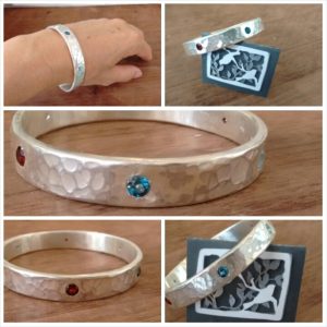 Commissioned bangle - very solid sterling silver with rubies and toapz stones all around